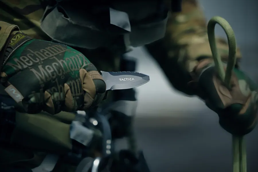 Gloved hands passing a blade, close detail of glove and edge
