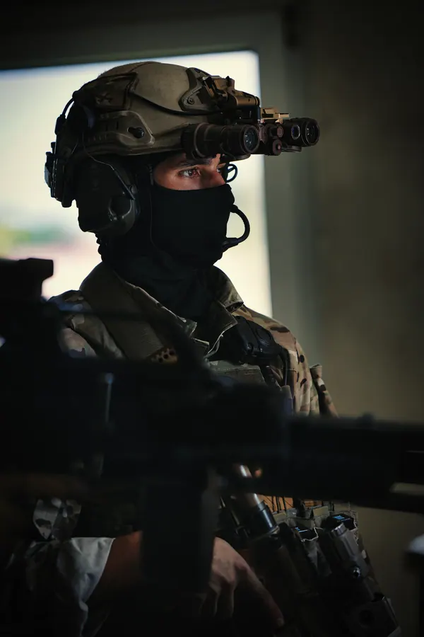 Operator with night vision at a window position, machine gun on the frame