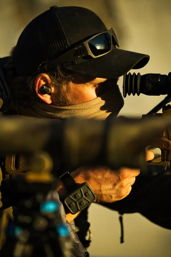 Marksman behind the scope, cap and comms, weapon supported