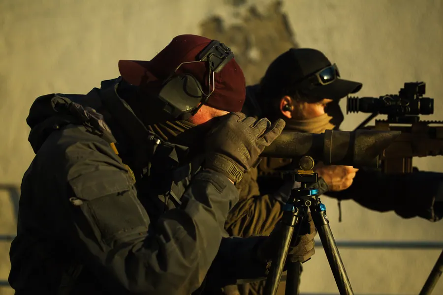Shooter and spotter working together at a bipod position