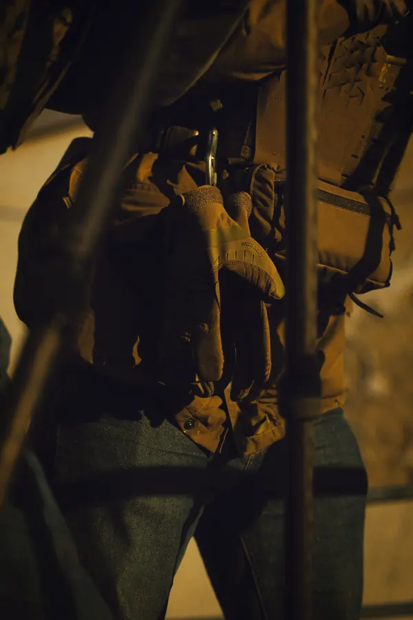 Shooter in shadow behind scaffold, weapon supported on the bipod