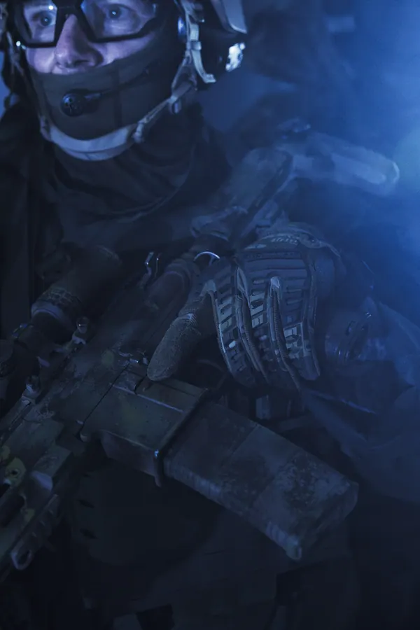 Operator in blue night light, carrier front and magazine pouches lit