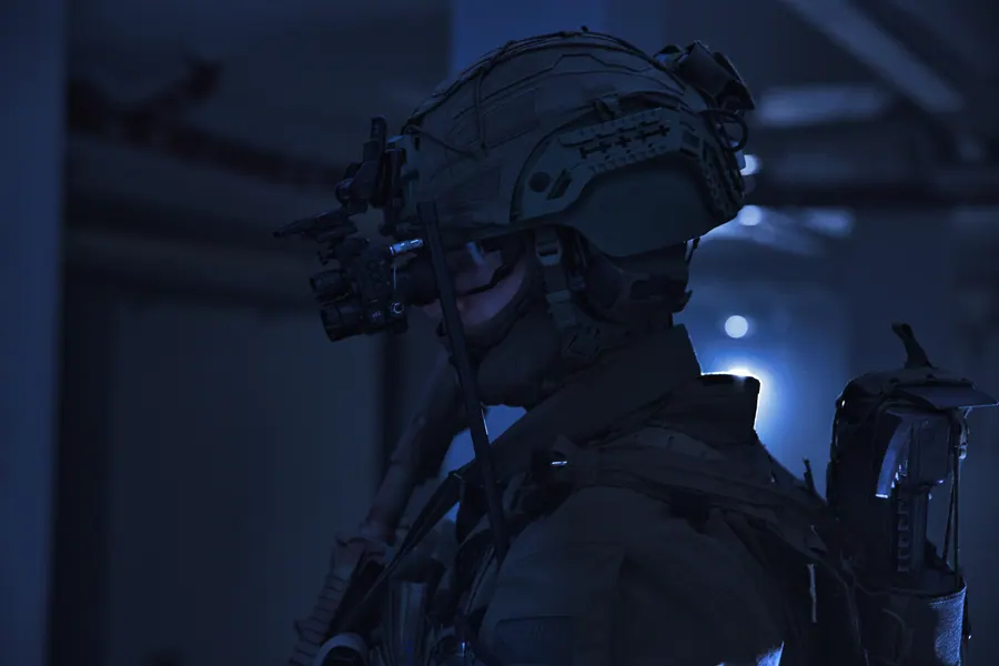 Helmet and night vision in profile under cold interior light