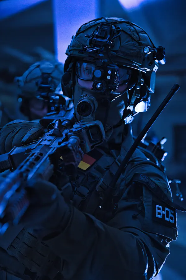 Operator under night vision working through a building