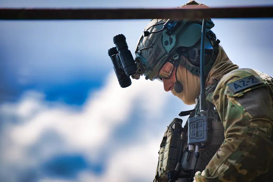 Rope work at height, operator in profile above the cloud line