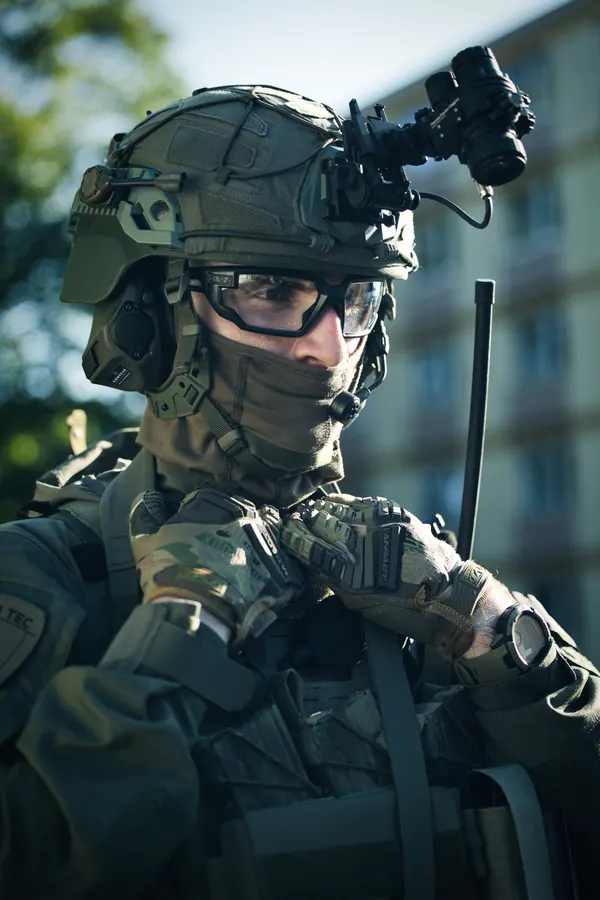 Portrait of an operator in front of a building, helmet and headset in daylight