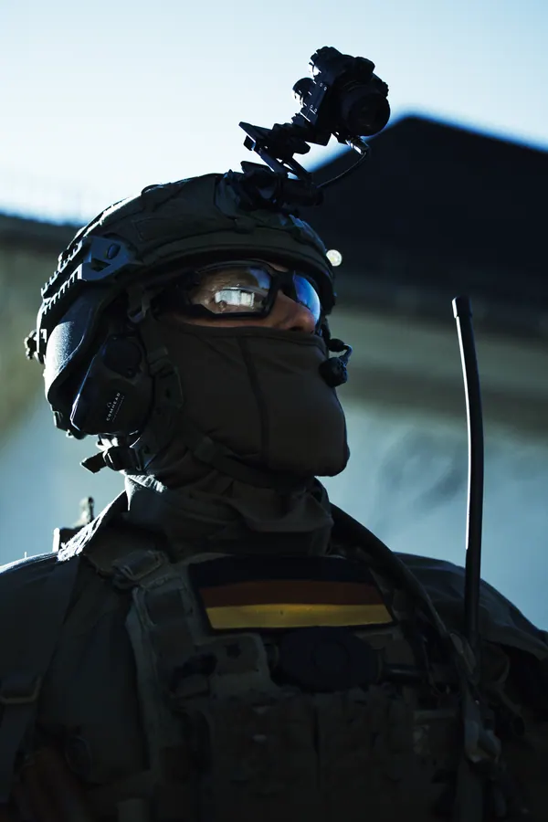 Operator in front of a building, helmet and headset against the roofline