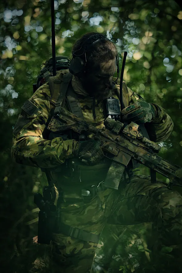 Operator kneeling in the green, kit carried under load